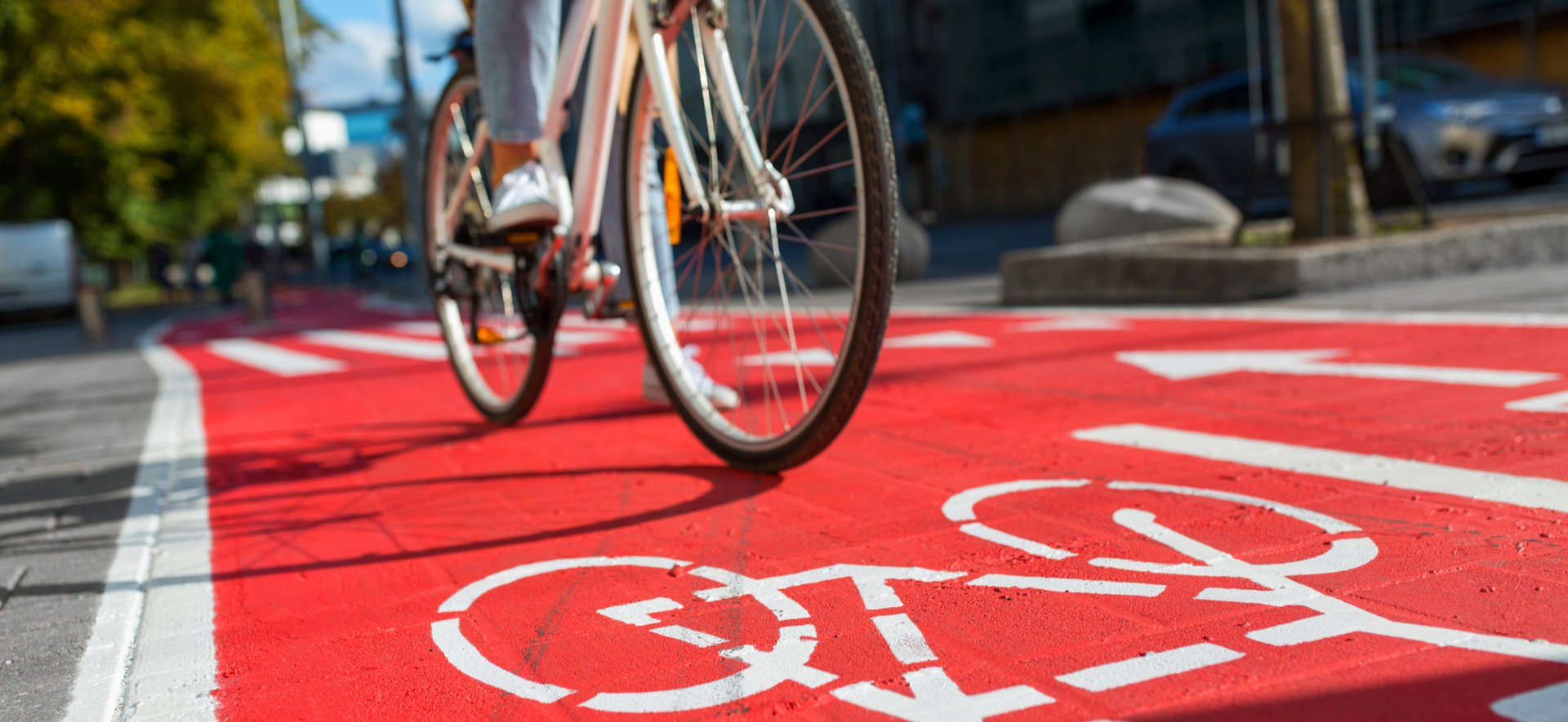 Image of bicyclist riding on a red bike lane