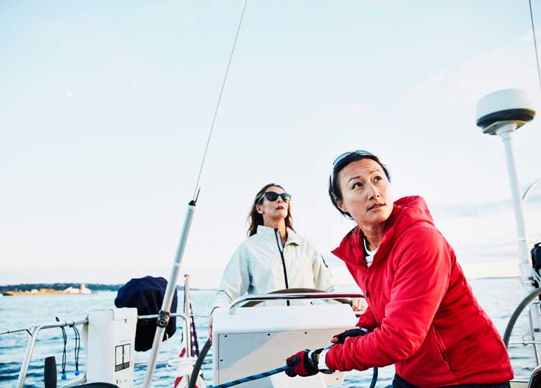 A pair of sailors steer a ship forward