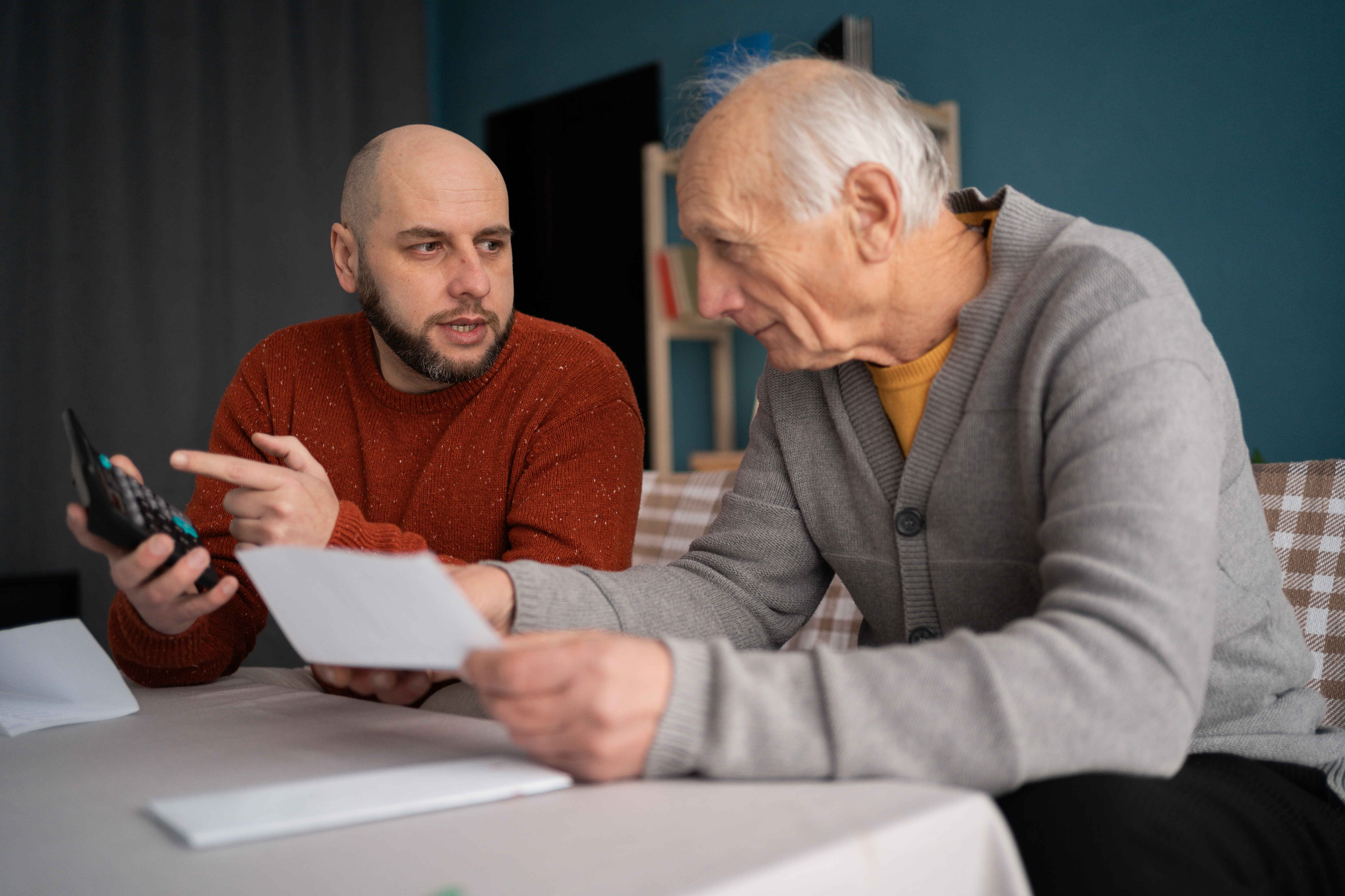 Son explaining life insurance to older father