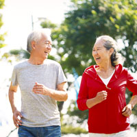 An elderly couple run together