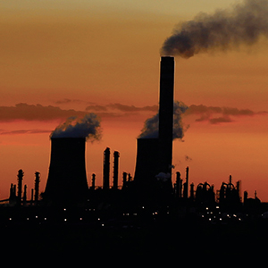 Industrial smokestacks at dusk