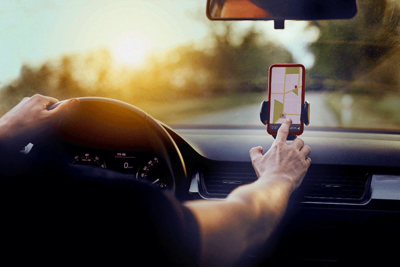 A man driving and using GPS on his phone