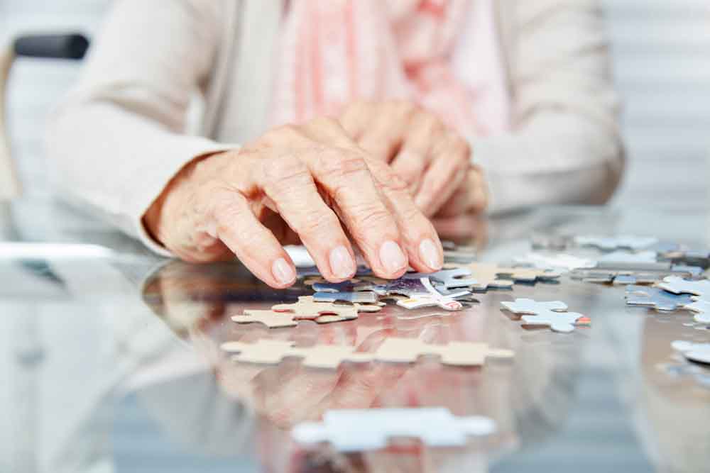 Elderly person completing a puzzle
