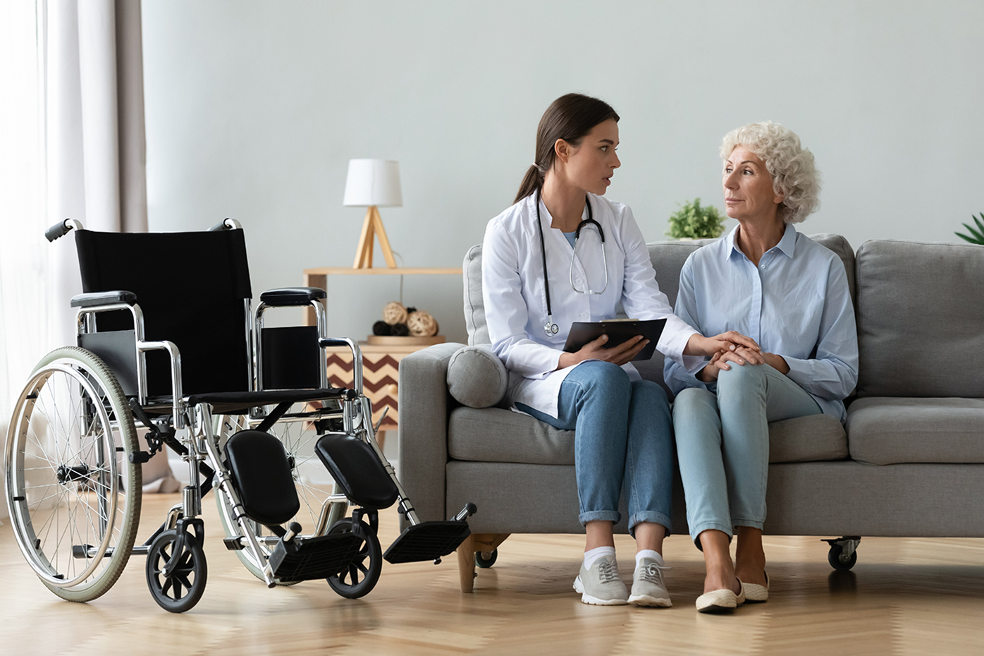 Nurse cares for wheelchair bound older woman
