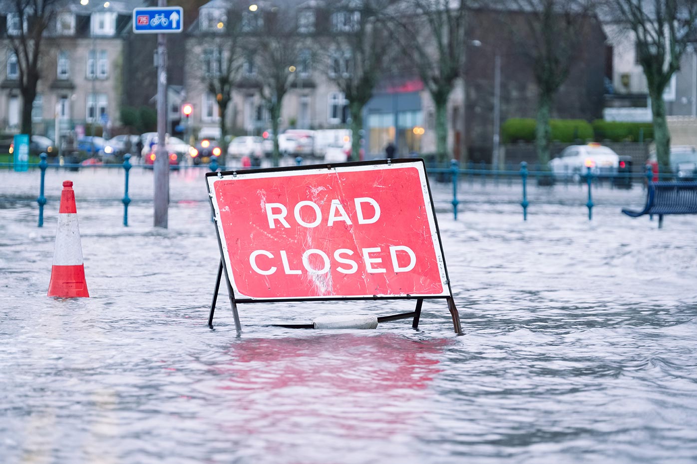 Road closed sign in flood water