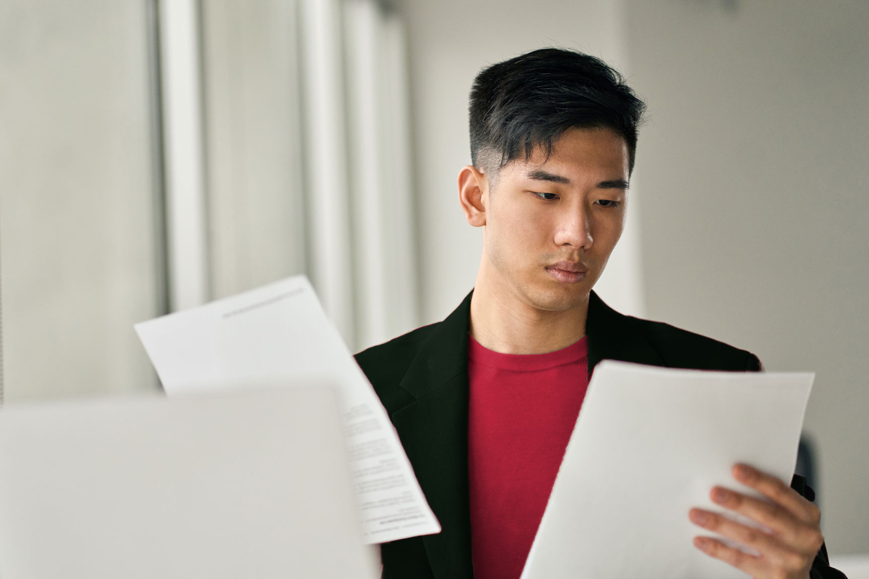 A man reading two different reports.