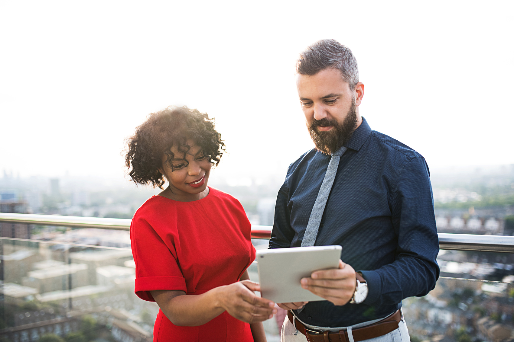 Behavioral Science A pair of colleagues review a tablet together.