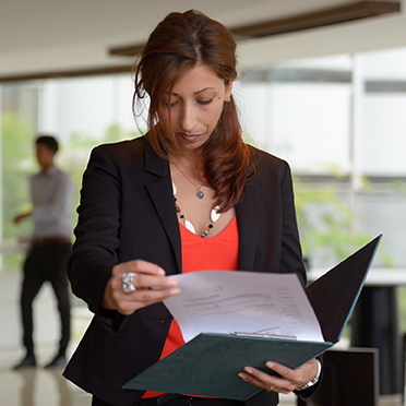 Hispanic woman looking at paperwork