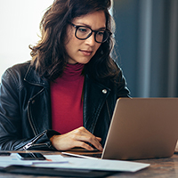 Woman sitting at a desk working on a laptop