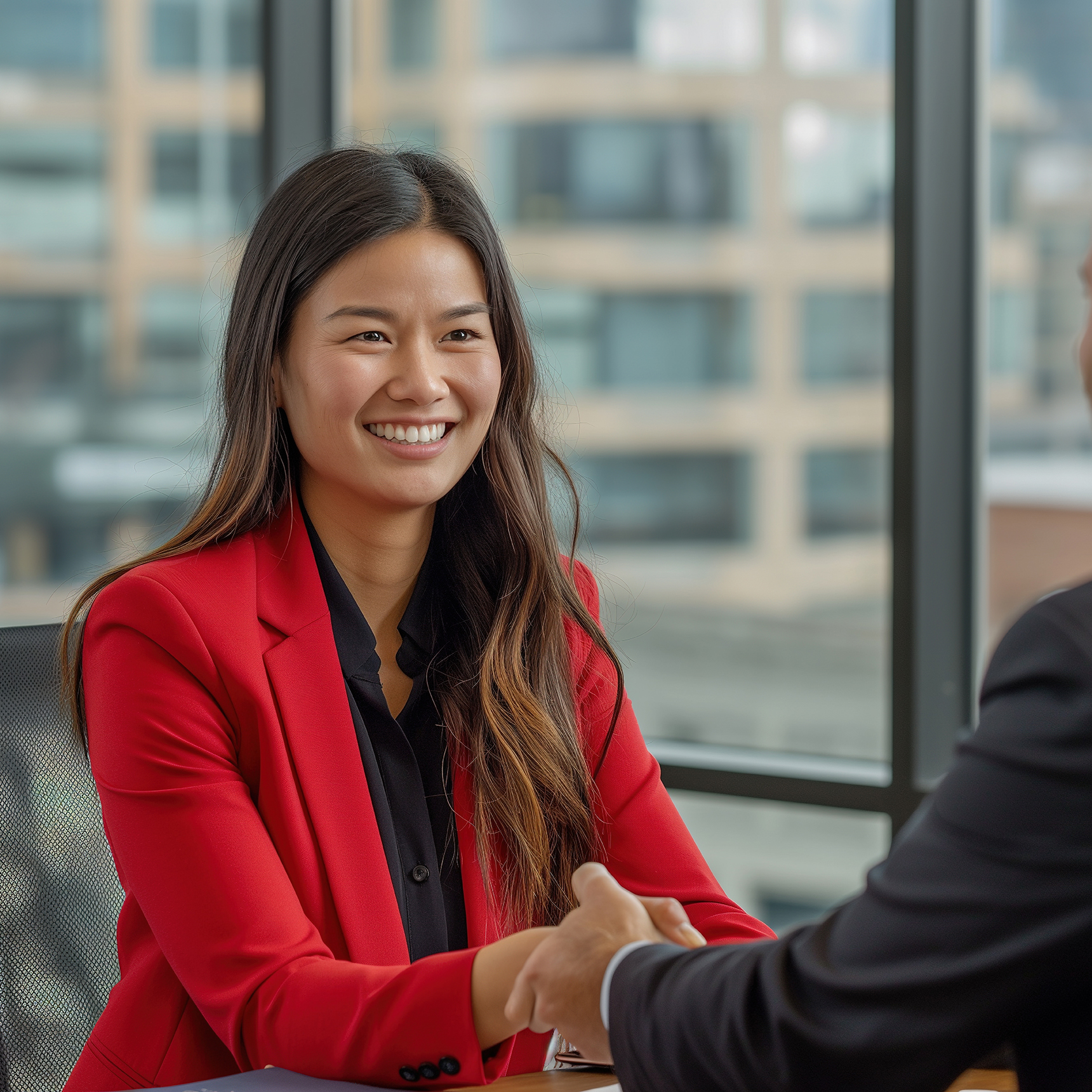 Woman shaking hands after being offered a job